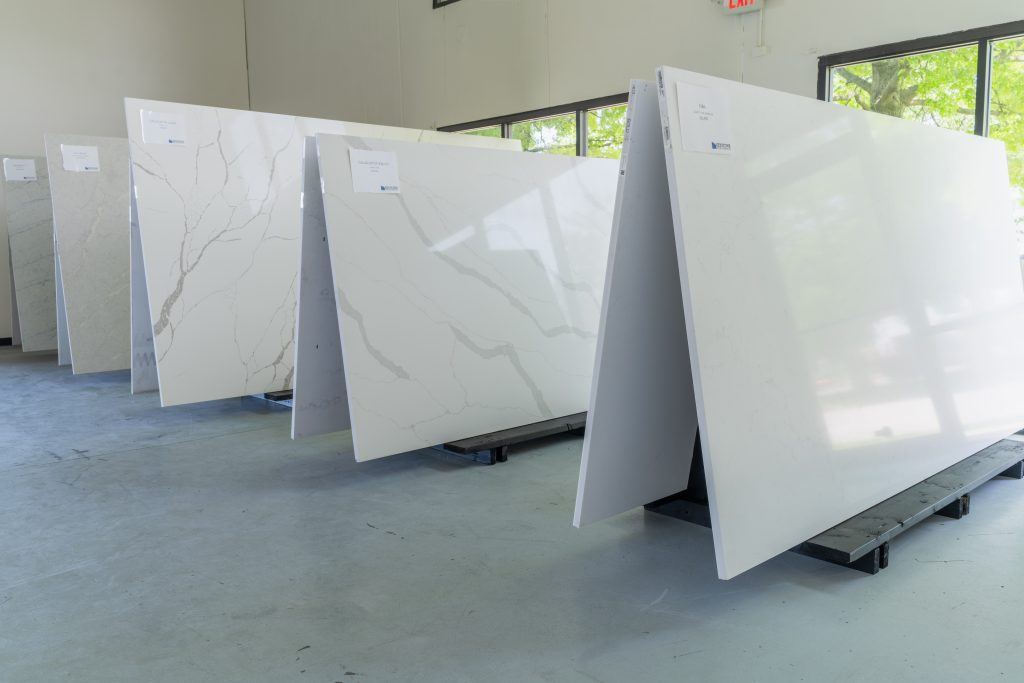 Large quartz countertop slabs displayed inside the Keystone Solid Surfaces Lee’s Summit showroom.